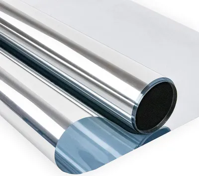 A roll of reflective window film is shown, partially unrolled.