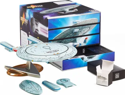 A Star Trek model kit and its packaging are displayed on a white background.