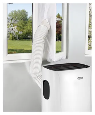 A portable air conditioner unit is shown indoors, with its exhaust hose connected to a window seal kit and extending out of a window.