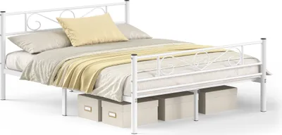 A white metal bed frame with a mattress, pillows, and a blanket, set against a white background. Storage boxes are placed underneath the bed.