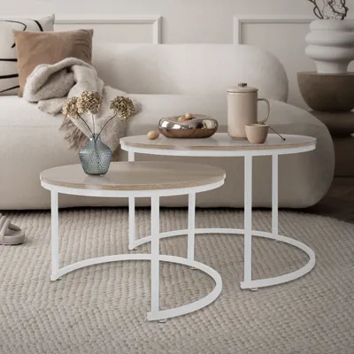 A living room scene with a couch and nesting coffee tables.