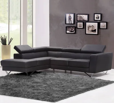 A modern living room with a sectional sofa and a shaggy rug.