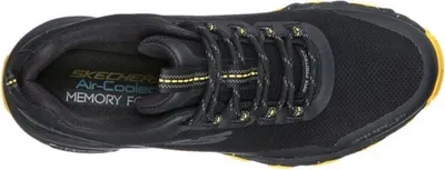 Top-down view of a black and yellow athletic shoe.