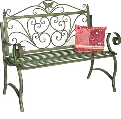 A green metal garden bench with a decorative scrolled back and a patterned cushion.