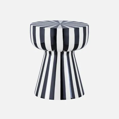 A black and white striped stool against a light gray background.