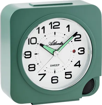 A close-up studio shot of a green analog alarm clock.