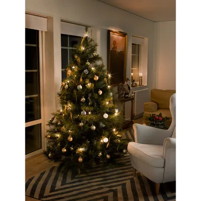 A decorated Christmas tree in a living room setting.