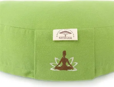 A close-up view of a green meditation cushion with a logo and a lotus flower with a meditating figure.