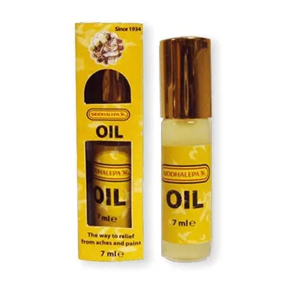 A product shot of a small bottle of oil and its packaging, presented side-by-side against a white background.