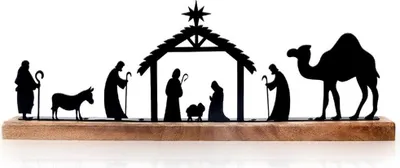 A silhouette of a nativity scene on a wooden base.