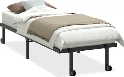 A folded bed frame with a mattress and bedding on it, shown from a side angle.