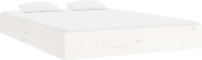 A white wooden bed frame with two white pillows on top, shown from a side angle.