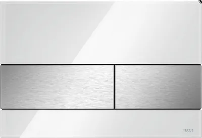 A close-up, front-facing studio shot of a white and brushed stainless steel toilet flush plate.