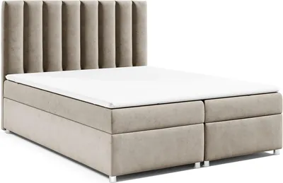 A studio shot of a beige upholstered bed with a white mattress and topper, against a white background.