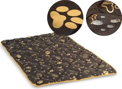A quilted pet mat with paw print and bone patterns.