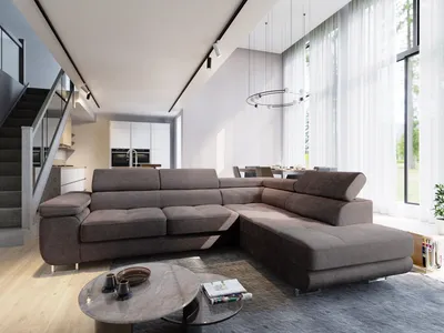 A modern living room with a large sectional sofa, coffee table, and stairs leading to an upper level.