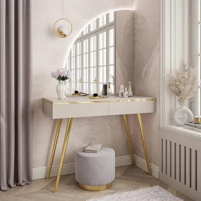 A vanity table with a mirror, stool, and decorative items in a room.
