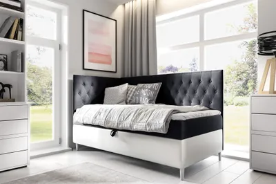 A bedroom scene with a bed, dresser, and bookshelf.