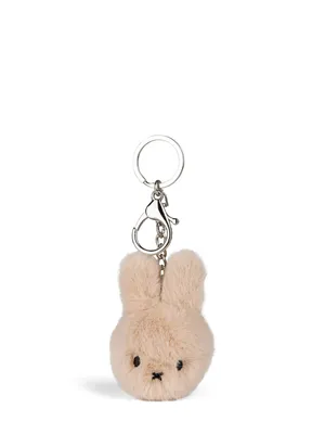 A fluffy beige Miffy bunny keychain is shown against a white background.