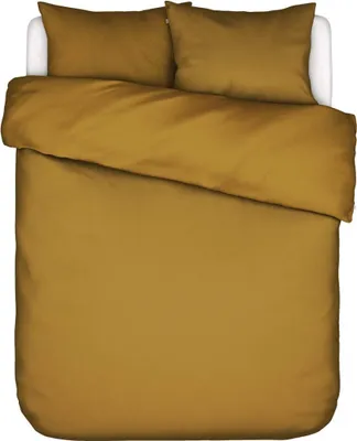 A top-down view of a bed with golden-brown bedding.