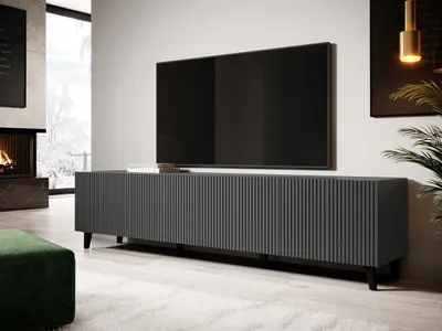 A modern living room with a TV stand and television.