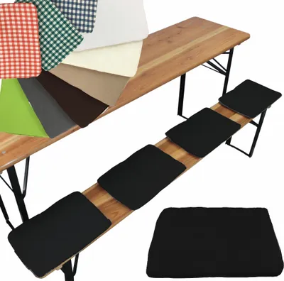 A collection of fabric swatches and black seat cushions displayed on and next to a wooden beer bench.