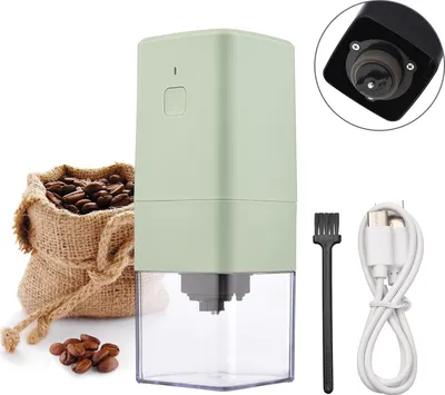 A portable electric mini coffee grinder with accessories, coffee beans, and a burlap sack.