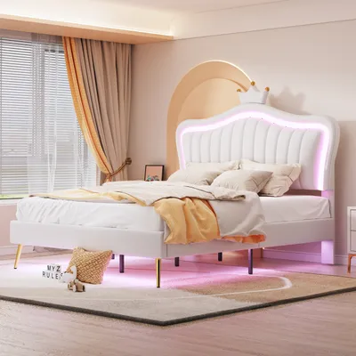 A bedroom scene featuring a white upholstered bed with a crown-shaped headboard and LED lighting.
