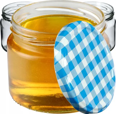 Three glass jars filled with honey, one with a blue and white checkered lid.