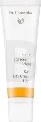 A white tube of Dr. Hauschka Rose Day Cream Light with an orange band near the bottom.