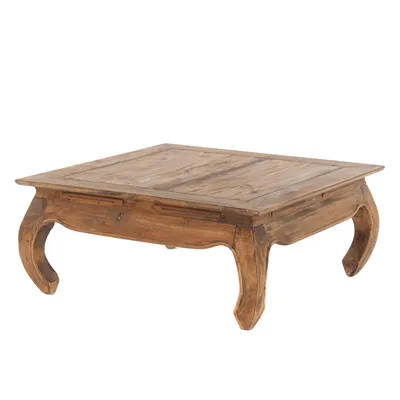 A wooden coffee table with ornate legs and a drawer is shown against a white background.
