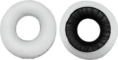 Two ear pads for headphones are shown side-by-side against a white background. One ear pad is white, and the other is white with a black interior.