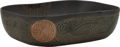 A black ceramic basin with intricate carvings.