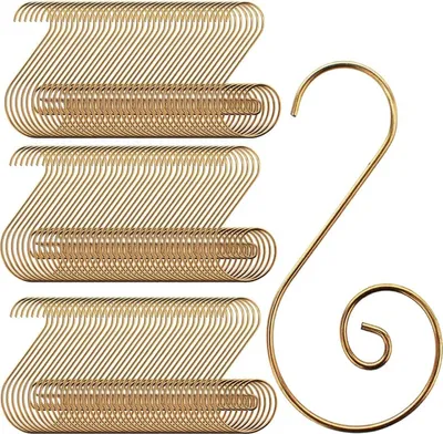 A stack of gold-colored S-hooks for hanging Christmas ornaments, with one hook shown separately on the right.