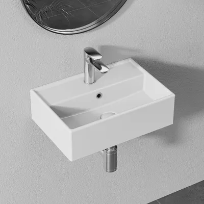 A white wall-mounted sink with a chrome faucet is shown.