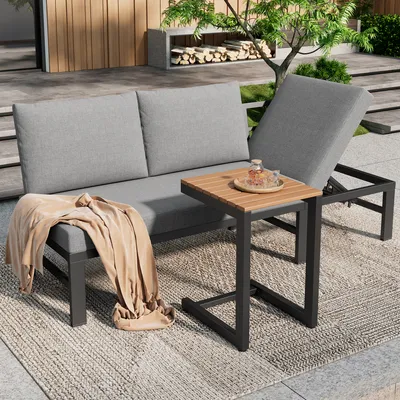 Outdoor patio furniture set with sofa and side table.