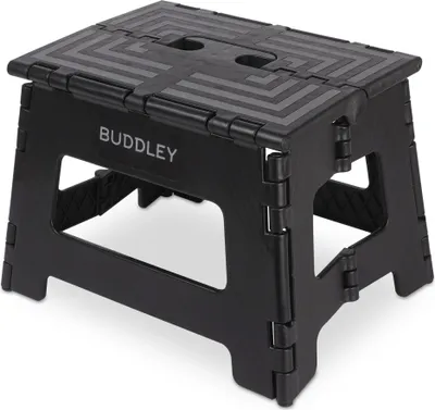 A black folding step stool.