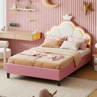 A child's bedroom with a pink bed, desk, and decorative elements.