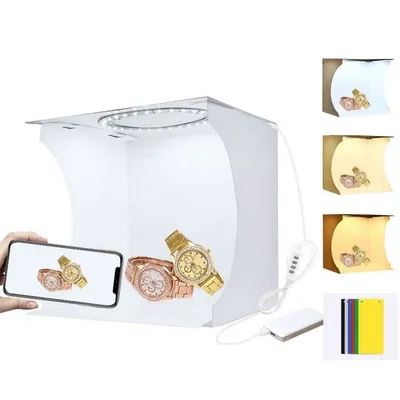 Produktbild von 1 Stück verstellbare Fotostudio-Lichtbox aus hochwertigem, lichtdurchlässigem Kunststoff mit integrierter LED-Beleuchtung. Die kompakte Mini-Fotolichtbox (24 cm x 23 cm x 22 cm) bietet professionelle Beleuchtung mit zwei Farbtemperaturen (6500K für natürliche Helligkeit, 3200K für warme Akzente) und ist speziell für kleine Produkte wie Schmuck, Uhren, Accessoires oder Spielzeug konzipiert. Mit 6 wechselbaren Hintergründen, USB-Stromversorgung und faltbarem Design ist sie sofort einsatzbereit – ob zu Hause,