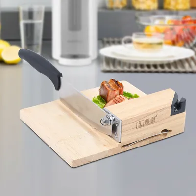 A kitchen slicer with a wooden base and a metal blade, slicing a piece of meat on a cutting board.