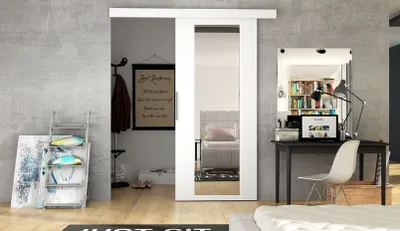 A modern bedroom with a sliding door, desk, and ladder.