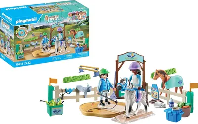 A Playmobil Horses of Waterfall playset featuring a modern riding school with figures, horses, and accessories, along with its packaging.