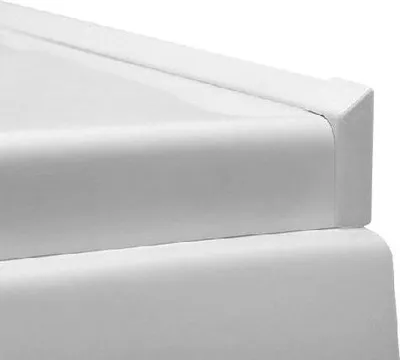 A close-up view of a white corner of a bathtub trim or similar product.