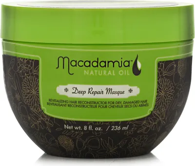 A product shot of a hair masque in a green and brown tub.