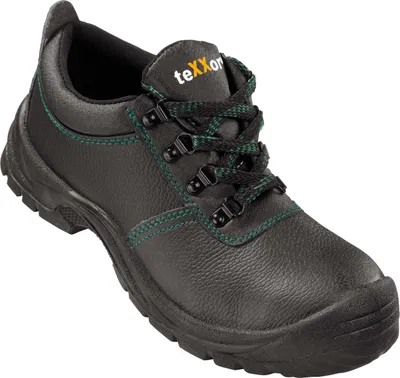A black safety shoe with green stitching and laces, shown from a slightly elevated side angle against a white background.