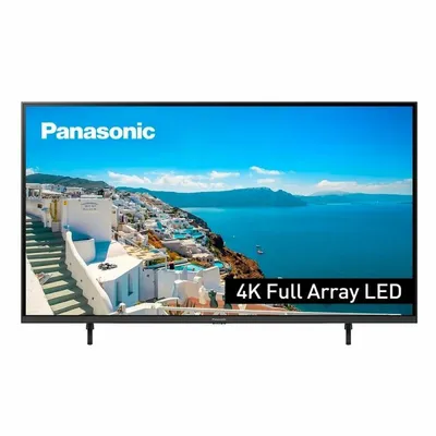 A Panasonic TV displaying a scenic image of a coastal town.
