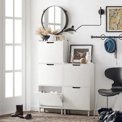 A hallway or entryway scene featuring a white shoe cabinet, a chair, and a mirror.