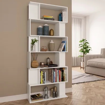 A white bookshelf filled with decorative items and books, placed in a living room setting next to a sofa and a plant.