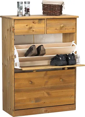 A wooden shoe cabinet with two drawers and two flip-down doors, displaying shoes inside.