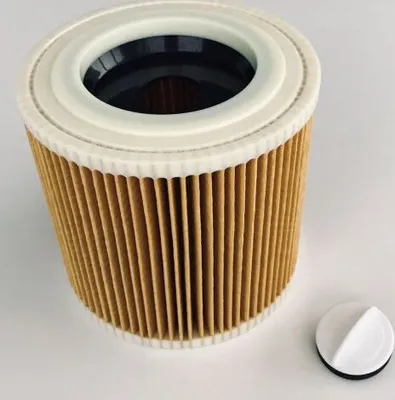A product shot of a cylindrical air filter with a white top and bottom, and a pleated brown filter medium. A small white cap is placed to the right of the filter.